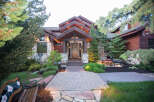 This stunning home boasts a beautiful stone facade and a welcoming wooden door.