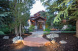This stunning property showcases a beautiful stone pathway leading to a luxurious home.