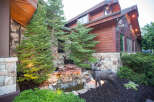This stunning property boasts a beautiful exterior with a combination of stone and wood siding, creating a warm and inviting atmosphere.