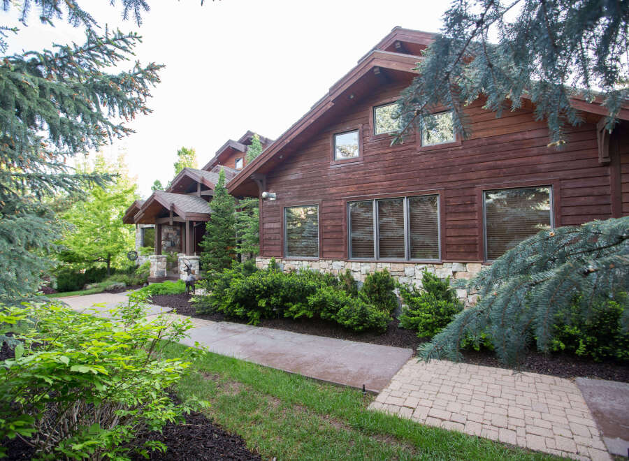 This stunning property showcases a beautiful wooden exterior, exuding warmth and elegance.
