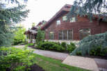 This stunning property showcases a beautiful wooden exterior, exuding warmth and elegance.