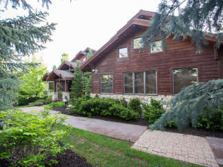 This stunning property showcases a beautiful wooden exterior, exuding warmth and elegance.