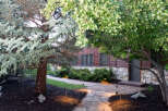 Discover the charm of this property with its inviting stone pathway leading to a beautifully designed home.