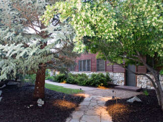 Discover the charm of this property with its inviting stone pathway leading to a beautifully designed home.