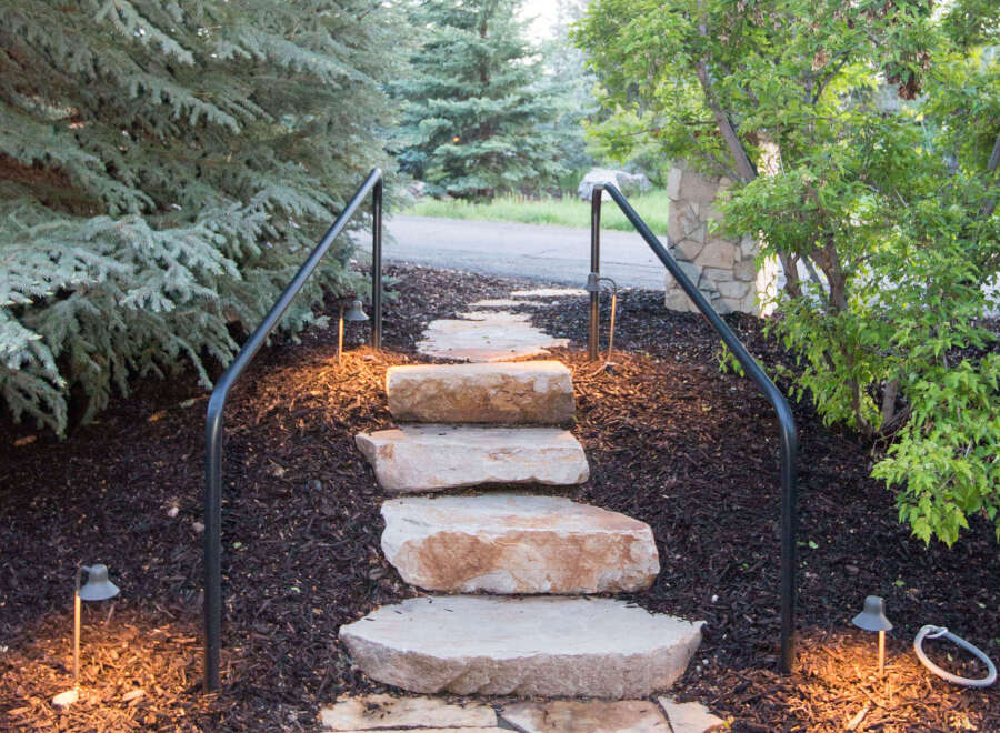 This property features a charming stone pathway leading up to the entrance, creating a welcoming ambiance.