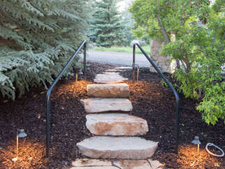 This property features a charming stone pathway leading up to the entrance, creating a welcoming ambiance.