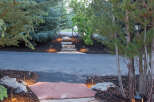 Discover the charm of this beautifully landscaped property, featuring a flagstone pathway that leads to a welcoming entrance.