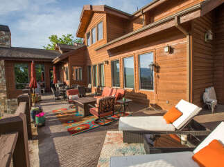 Enjoy the stunning views from this luxurious wooden house with a spacious patio.