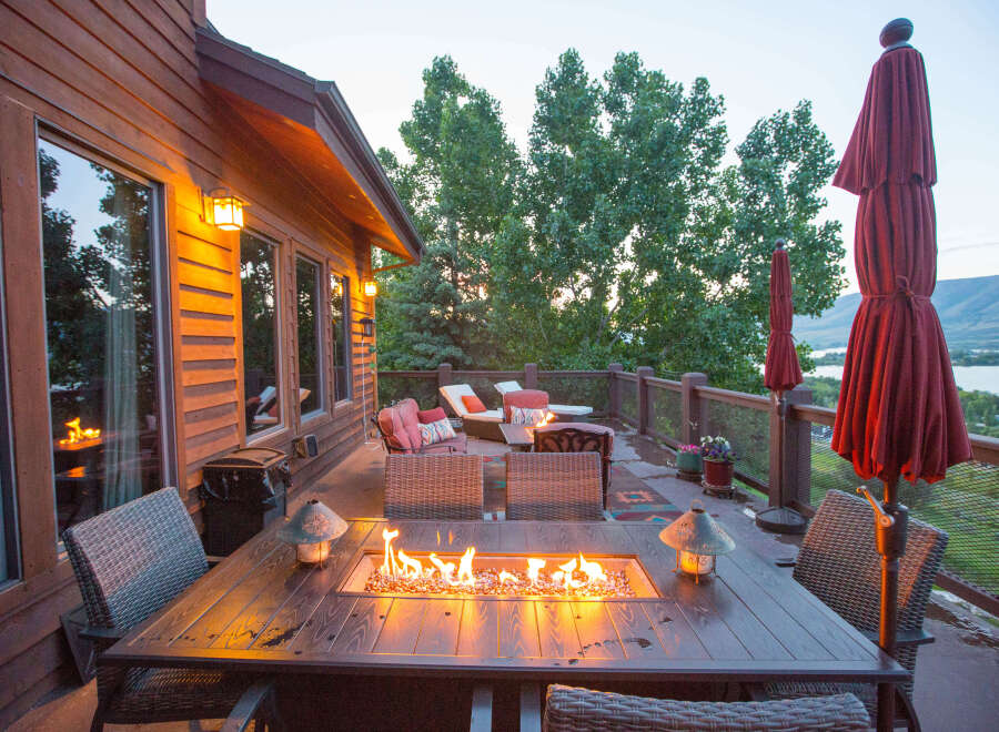 Enjoy the perfect evening on this stunning deck, complete with a cozy fire pit table.