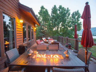 Enjoy the perfect evening on this stunning deck, complete with a cozy fire pit table.