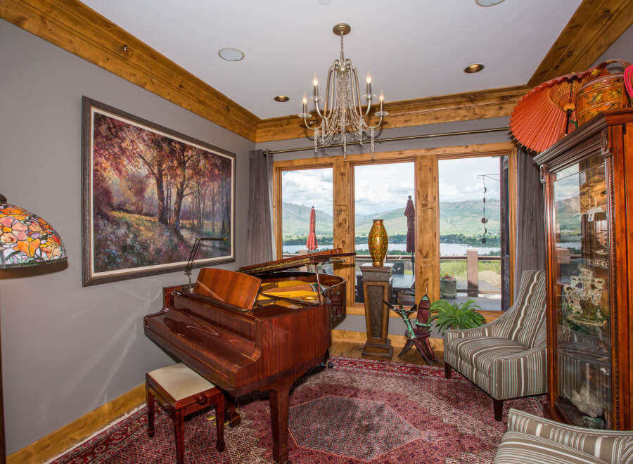 This stunning living space features a grand piano, perfect for musical enjoyment.