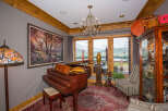 This stunning living space features a grand piano, perfect for musical enjoyment.