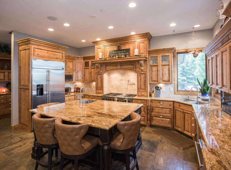 This stunning kitchen boasts custom cabinetry and a spacious island with seating, perfect for entertaining.