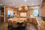 This stunning kitchen boasts custom cabinetry and a spacious island with seating, perfect for entertaining.