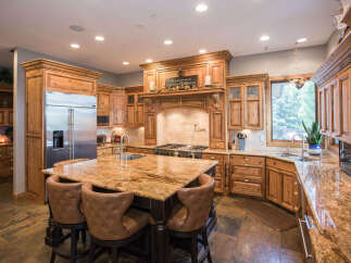 This stunning kitchen boasts custom cabinetry and a spacious island with seating, perfect for entertaining.