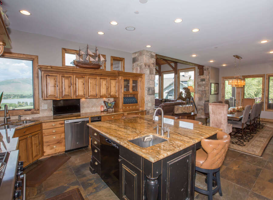 This stunning kitchen boasts a large island with a granite countertop, perfect for meal prep and entertaining.