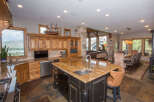 This stunning kitchen boasts a large island with a granite countertop, perfect for meal prep and entertaining.