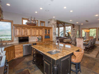 This stunning kitchen boasts a large island with a granite countertop, perfect for meal prep and entertaining.