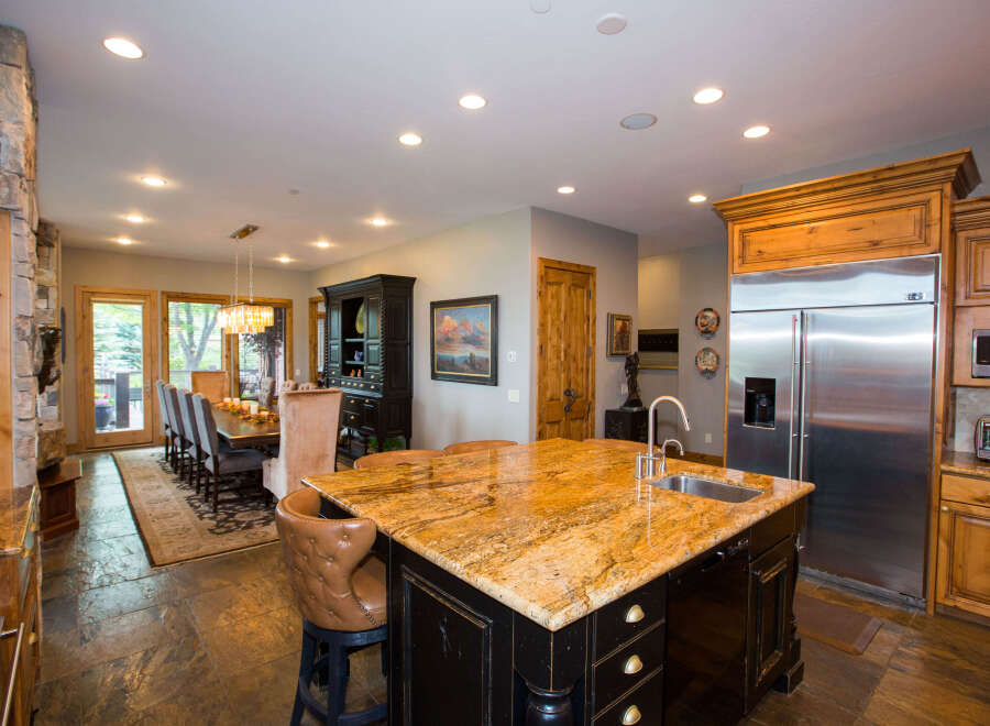 This stunning kitchen boasts a large island with a granite countertop, perfect for meal prep and entertaining.
