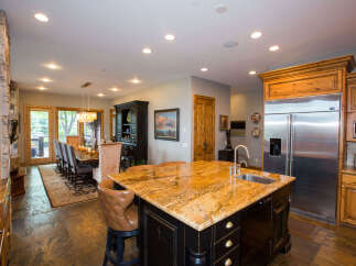 This stunning kitchen boasts a large island with a granite countertop, perfect for meal prep and entertaining.