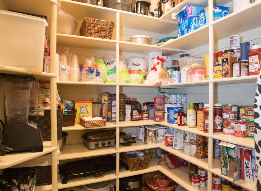 This well-organized pantry offers ample storage space for all your culinary needs.