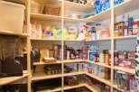 This well-organized pantry offers ample storage space for all your culinary needs.