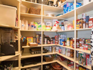 This well-organized pantry offers ample storage space for all your culinary needs.