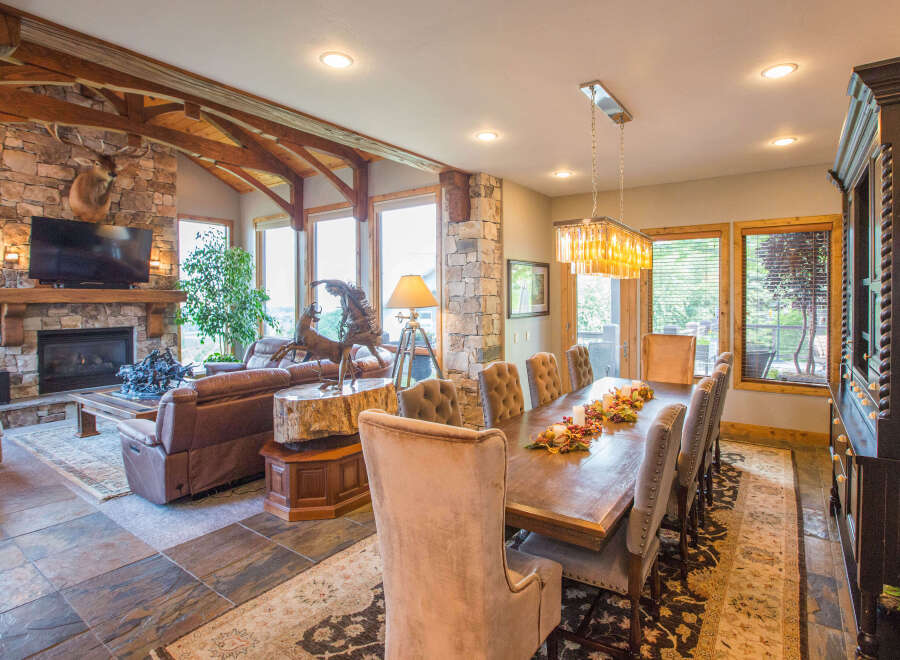 This stunning property boasts a luxurious living space with a cozy fireplace and a mounted TV, perfect for relaxing evenings.