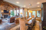 This stunning property boasts a luxurious living space with a cozy fireplace and a mounted TV, perfect for relaxing evenings.