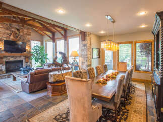 This stunning property boasts a luxurious living space with a cozy fireplace and a mounted TV, perfect for relaxing evenings.