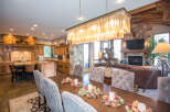 This luxurious dining room features a stunning chandelier and a large wooden dining table, perfect for hosting gatherings.