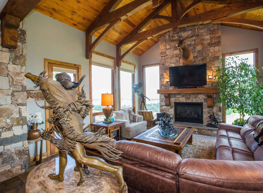 Step into luxury with this stunning living space, featuring a cozy fireplace and a beautiful stone accent wall.