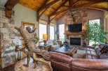 Step into luxury with this stunning living space, featuring a cozy fireplace and a beautiful stone accent wall.
