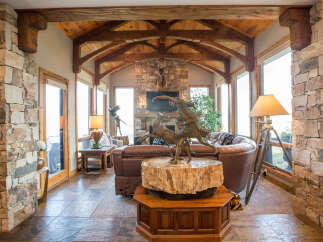 Step into luxury with this stunning property featuring exquisite stone accents and a warm, inviting ambiance.