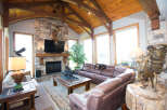 Step into luxury with this stunning living room, featuring a cozy fireplace and a majestic elk mount.