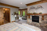Discover luxury living in this stunning bedroom, featuring a cozy fireplace and elegant decor.