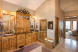 This luxurious bathroom boasts custom wooden cabinetry, offering ample storage and a touch of rustic elegance.