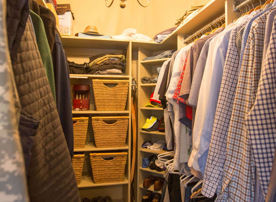 Step into this well-organized walk-in closet, a haven for your wardrobe.