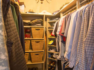 Step into this well-organized walk-in closet, a haven for your wardrobe.