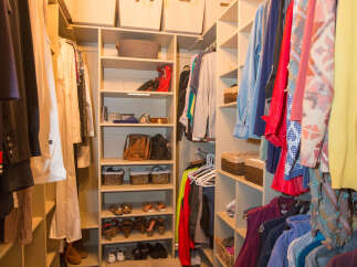 Step into this well-organized walk-in closet, offering ample storage for your wardrobe.