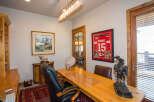 Step into this inviting home office, featuring a stylish desk and comfortable seating.