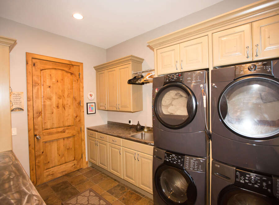 This laundry room features a modern design with a sleek washer and dryer set.