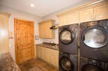 This laundry room features a modern design with a sleek washer and dryer set.
