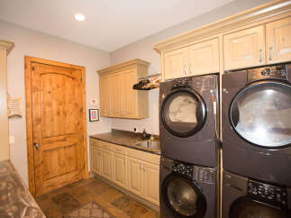 This laundry room features a modern design with a sleek washer and dryer set.