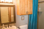 This bathroom features a stylish pedestal sink and a modern toilet.