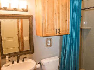 This bathroom features a stylish pedestal sink and a modern toilet.