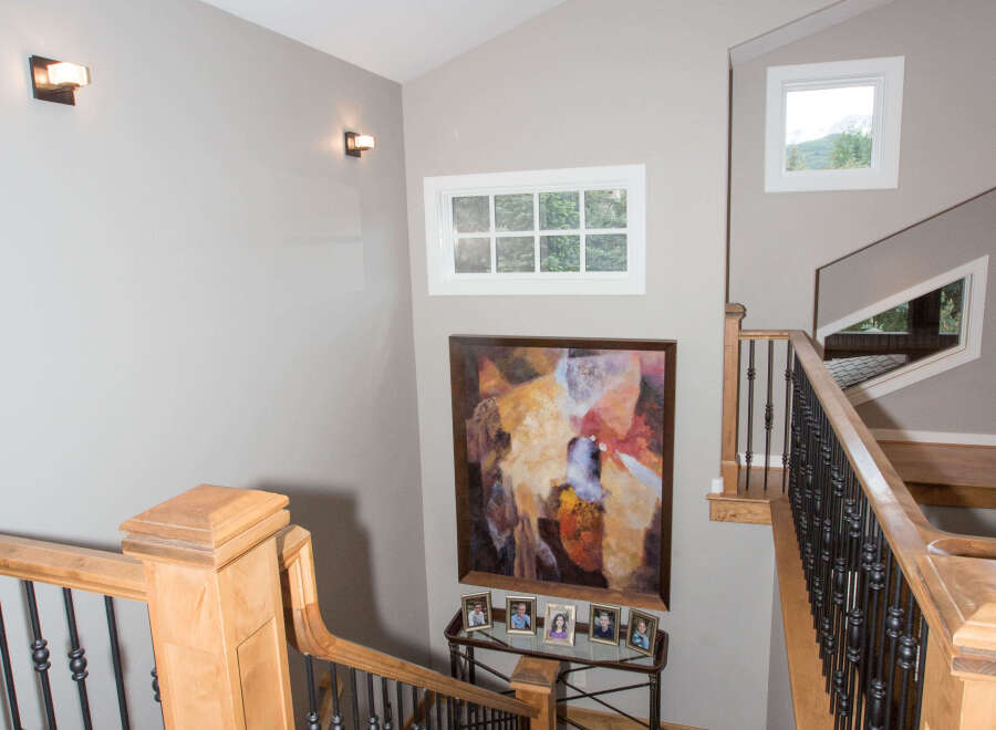 This stunning property features a grand staircase with elegant wooden accents and wrought iron railings.