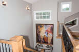 This stunning property features a grand staircase with elegant wooden accents and wrought iron railings.