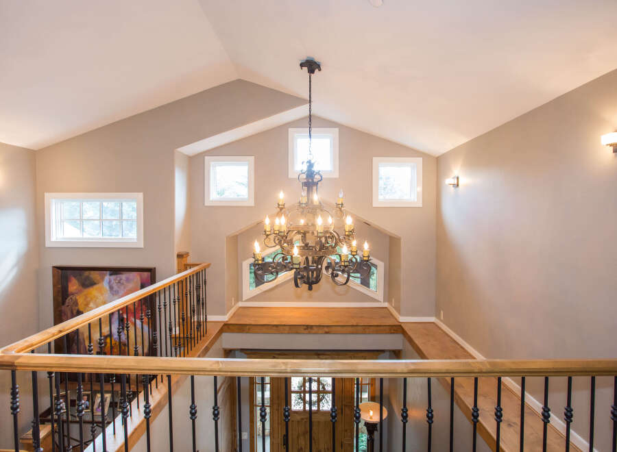 This stunning entryway boasts a grand chandelier and a beautiful staircase.