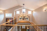 This stunning entryway boasts a grand chandelier and a beautiful staircase.